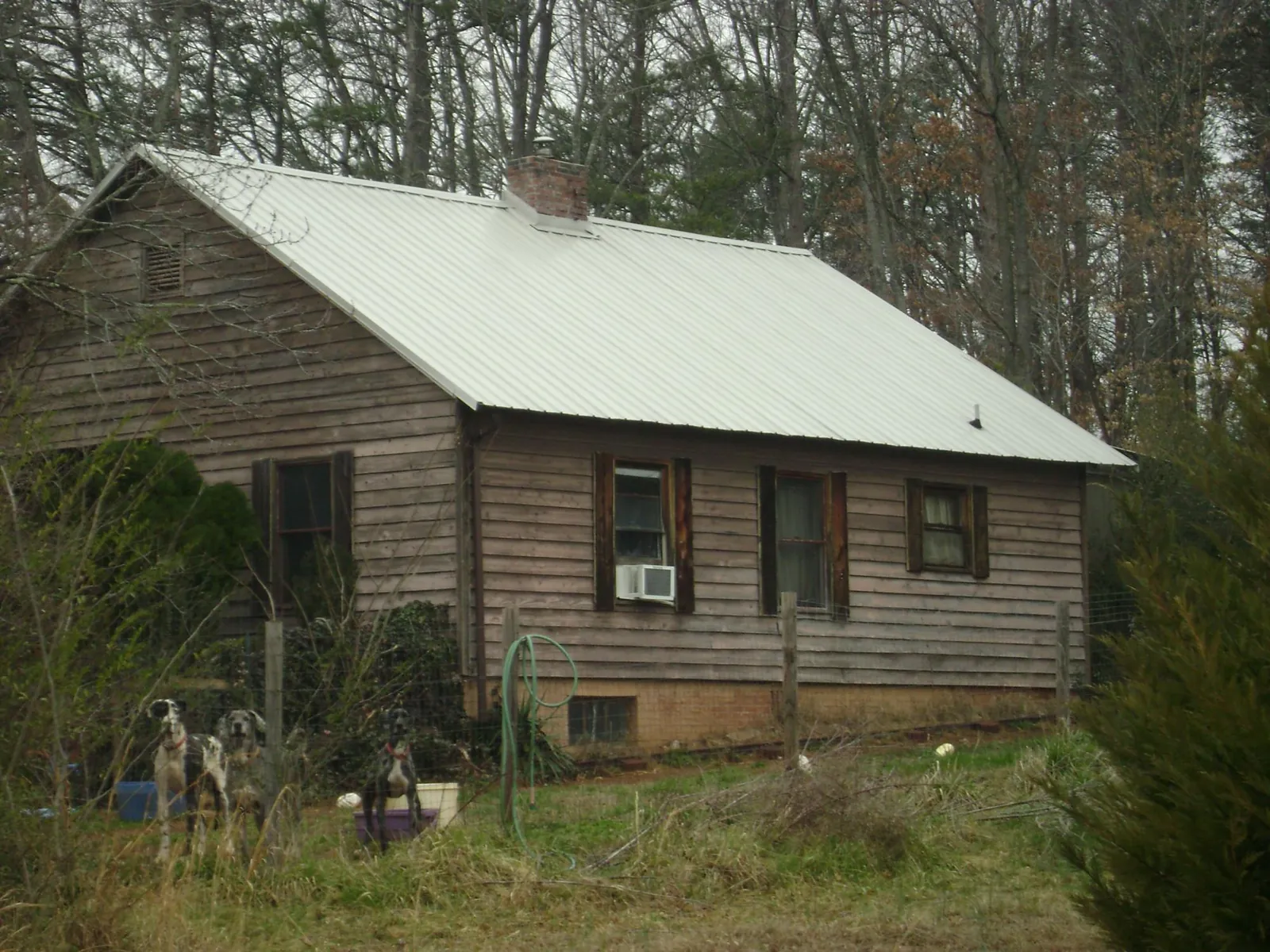 White metal roof on an old wood sided farmhouse, from a Metal Roof Installation job in Kathleen